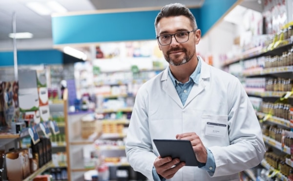 I manage my pharmacy with wireless technology. Portrait of a handsome mature pharmacist using a digital tablet in a pharmacy. Mortgages For Locum Pharmacists